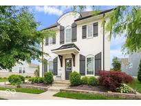 Charming two-story home featuring a white brick exterior, black shutters, and beautifully landscaped front yard at 1655 Avondale Dr, Westfield, IN 46074