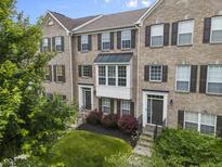 Charming brick townhome with well-maintained landscaping and traditional architectural details at 258 Coatsville Dr, Westfield, IN 46074