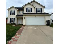Two-story home featuring a two car garage, black shutters, and a well-manicured lawn at 3065 Hemlock Way, Indianapolis, IN 46203