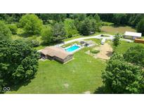 Expansive property with a pool, pond, large lawn and mature trees offering privacy and space at 3325 Kivett Ln, Martinsville, IN 46151