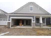 New construction features a two-car garage and stone accents on the gray exterior at 3599 Hauser Ct, Bargersville, IN 46106