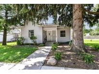 Charming single-story home with a well-maintained yard, mature tree, and inviting front entrance at 402 E 4Th St, Sheridan, IN 46069