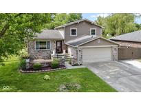 Charming two-story home with brick accents, well-maintained lawn, and attached two-car garage at 4718 Dancer Dr, Indianapolis, IN 46237