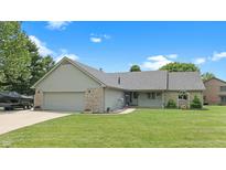 Charming ranch-style home featuring a manicured lawn, stone accents, and an attached two-car garage at 5431 Nathan Pl, Indianapolis, IN 46237