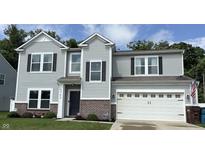 Charming two-story home featuring gray siding, black shutters, and a well-manicured front lawn at 5702 Deer Valley Ct, Columbus, IN 47201