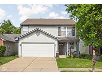 Charming two-story home with a two-car garage, tidy landscaping, and inviting front porch at 5966 Draycott Dr, Indianapolis, IN 46236