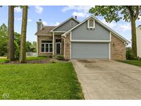 Charming brick and siding home with a well-manicured lawn and a two-car garage at 6518 Springview Dr, Avon, IN 46123
