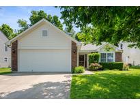 Charming single-Gathering home with a two-car garage, complemented by a lush green lawn and mature trees at 6963 N Abilene Way, McCordsville, IN 46055