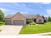 Brick ranch home with a three-car garage, well-kept lawn and manicured landscaping at 745 Ridge Gate Dr, Brownsburg, IN 46112