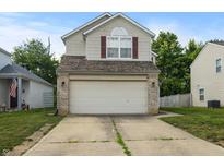 Two-story home featuring a two-car garage and concrete driveway, providing ample parking at 9125 Timpani Way, Indianapolis, IN 46231