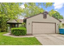 Charming home featuring a two-car garage, mature landscaping, and a well-maintained lawn at 11114 Wismar Dr, Indianapolis, IN 46235