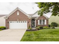 Charming brick home featuring a well-maintained lawn, two-car garage, and manicured landscaping at 13091 Duval Dr, Fishers, IN 46037