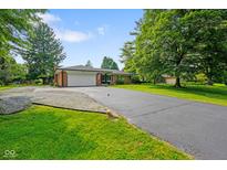 Charming ranch-style home featuring a brick exterior, two-car garage, and well-maintained landscaping at 1506 Bowman Dr, Greenfield, IN 46140