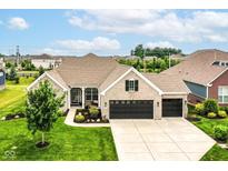 Beautiful single-Gathering home with a three-car garage, manicured lawn, and professional landscaping at 15097 Thoroughbred Dr, Fishers, IN 46040