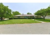 Charming one-story brick home with manicured lawn and mature trees, offering great curb appeal at 1910 Ivy Dr, Anderson, IN 46011