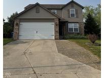 Traditional two-story home with a two-car garage, neutral siding, and a well-maintained front yard at 2540 Lullwater Ln, Indianapolis, IN 46229