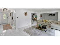 Open-concept living area with sleek marble flooring, modern decor, and seamless flow for entertaining at 3141 Citadel Ct, Indianapolis, IN 46268