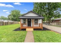 Charming single-story home featuring a cozy front porch and well-manicured lawn at 3453 W 12Th St, Indianapolis, IN 46222