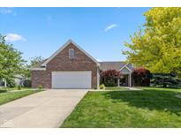 Charming brick home featuring a well-manicured lawn and an attached two-car garage at 3779 Crest Point Dr, Westfield, IN 46062