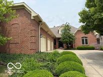 Beautiful brick home with a three-car garage and well-maintained landscaping in a suburban setting at 458 Burlington Ln, Carmel, IN 46032