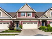 Charming townhome featuring a two-car garage, manicured landscaping, and a well-maintained facade at 478 Firefly Ln, Carmel, IN 46032