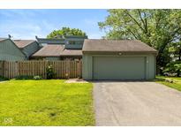 Charming home featuring an attached garage, a well-maintained lawn, and a cozy fenced-in yard at 4965 Hawthorne Way, Avon, IN 46123