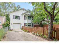 Charming two-story home with attached garage, bay window and lush landscaping at 5108 Riverview Dr, Indianapolis, IN 46208