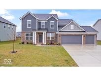 Charming two-story home with brick and siding, a manicured lawn, and a three-car garage at 5655 Lighthouse Dr, Brownsburg, IN 46112