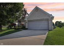Charming brick home with a two-car garage and well-maintained landscaping at 7456 Jack Pine Ct, Avon, IN 46123