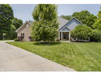 Inviting two-story home featuring a well-manicured lawn and beautiful mature trees offering great curb appeal at 815 Copperfield Ln, Danville, IN 46122