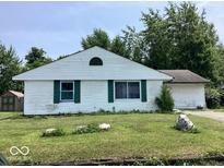 Single-story home showcasing classic white siding and green shutters at 9925 Catalina Dr, Indianapolis, IN 46235