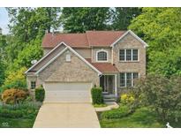 Charming two-story home with brick and siding exterior and well-maintained landscaping at 10402 Shakamak Way, Indianapolis, IN 46239