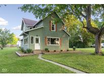 Charming two-story home with green siding, brown shutters, and a well-manicured lawn at 106 N Blake St, Sheridan, IN 46069