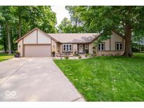 Charming single-story home featuring a well-manicured lawn and stone facade at 1304 Old Hickory Cir, Greenwood, IN 46142