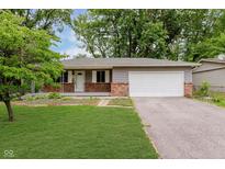 Charming single-story home featuring a brick facade, attached garage, and well-maintained lawn at 1410 Lawrence Ave, Indianapolis, IN 46227