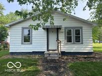 Quaint one-story home featuring neutral siding, trimmed windows, front entrance, and a well-manicured lawn at 1720 E Cornell Ave, Muncie, IN 47303