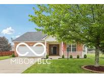Charming single story home features a two-car garage and a welcoming covered porch at 19146 Carol Cove Cir, Noblesville, IN 46062