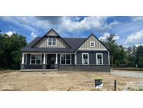 Beautiful new home showcasing dark gray siding and black brick, enhancing its curb appeal at 1960 Delp Ct, Avon, IN 46123