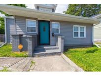 Charming home featuring a vibrant turquoise front door and a well-maintained exterior at 244 W 31St St, Indianapolis, IN 46208