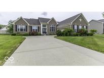 Charming brick home featuring a well-manicured lawn and an expansive driveway at 2502 Colinbrook Pkwy, Greenwood, IN 46143