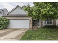 Charming brick and siding home with an attached garage and mature landscaping at 3714 Turfway Ct, Indianapolis, IN 46228