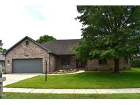 Charming brick home with a well-manicured lawn and mature trees, creating great curb appeal at 4723 Goldenrain Ct, Indianapolis, IN 46237