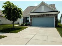 Charming single-Gathering home features a two-car garage, brick accents, and a meticulously maintained front yard at 4817 Allium Dr, Plainfield, IN 46168