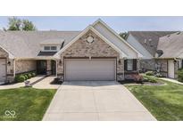 Charming single-story home with a brick facade, attached garage, and well-manicured lawn at 5351 Abbington Ave, Plainfield, IN 46168
