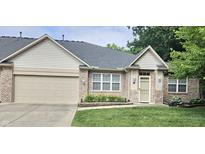 Charming brick home with well-manicured lawn and an attached garage, perfect for suburban living at 6956 Park Square Dr # D, Avon, IN 46123