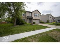 Charming two-story home with brick accents, attached garage, and well-manicured lawn at 7657 Wheatgrass Ln, Noblesville, IN 46062