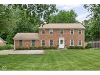 Charming brick two-story home featuring manicured lawn and inviting entrance at 8436 N Meridian St, Indianapolis, IN 46260