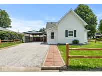 Charming home showcasing a well-manicured lawn and a convenient carport at 89 S Grant St, Martinsville, IN 46151