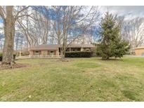 Charming single-story brick home with well-maintained lawn and mature trees in a peaceful neighborhood setting at 10130 Central Ave, Carmel, IN 46280