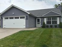 Charming single-story home with gray siding, attached garage, and well-maintained lawn at 10421 Sand Creek Blvd, Fishers, IN 46037